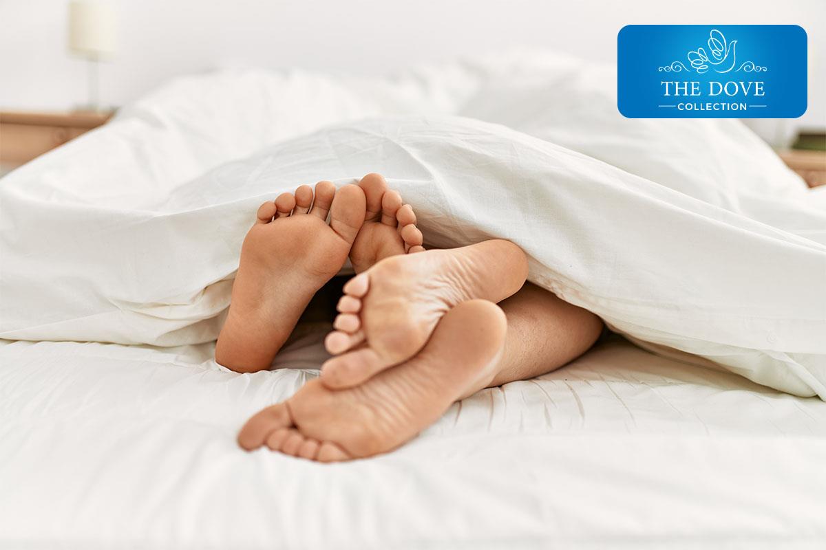 two feet showing under the covers on a mattress company mattress