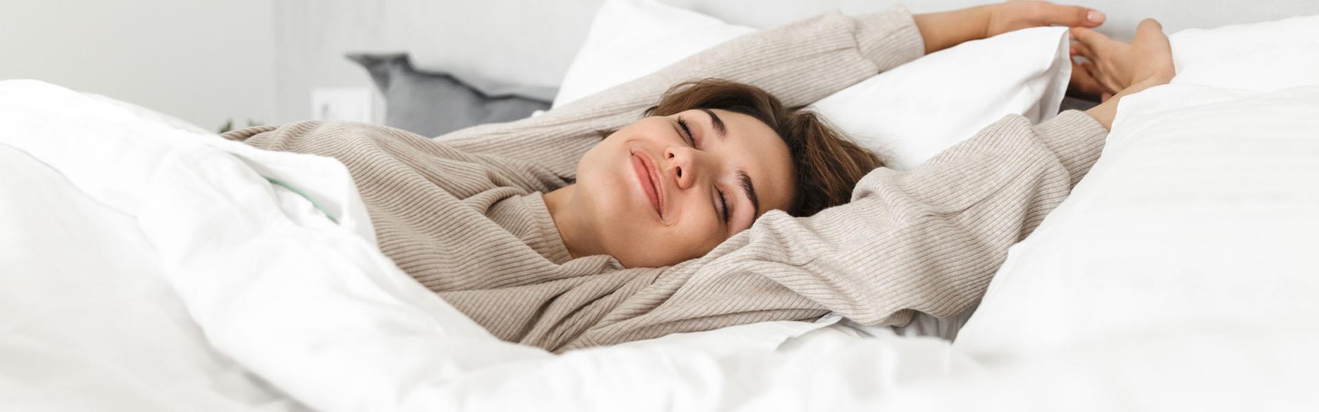 Woman stretching on comfortable mattress