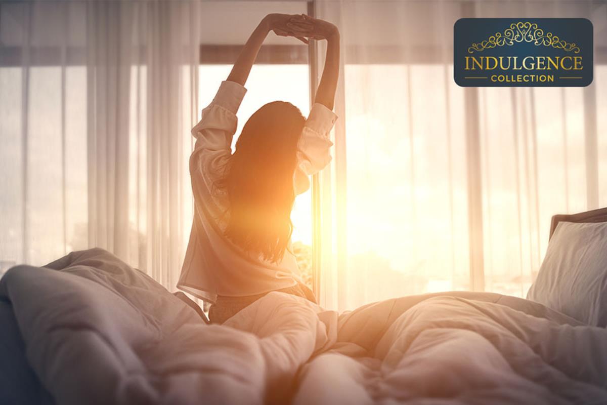 woman stretching on top of comfy looking mattress company mattress