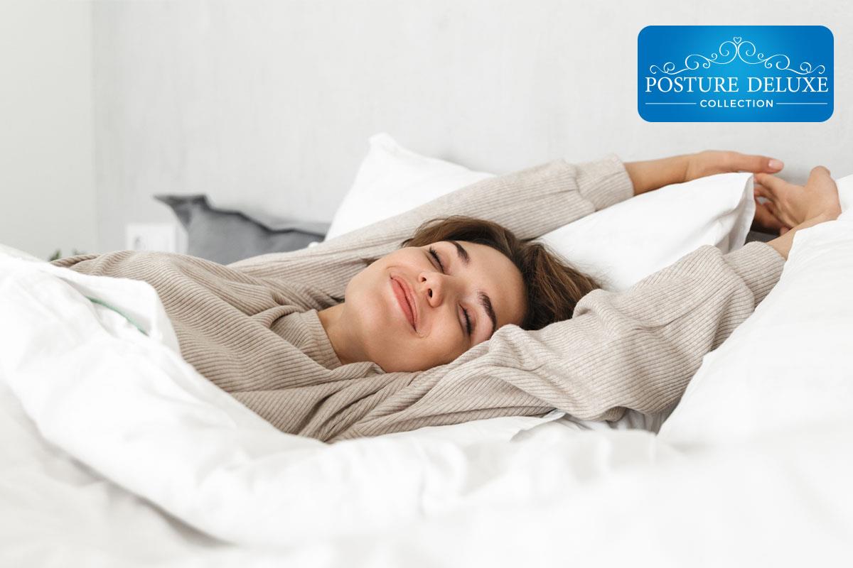 lady waking from a restful sleep on a mattress company mattress