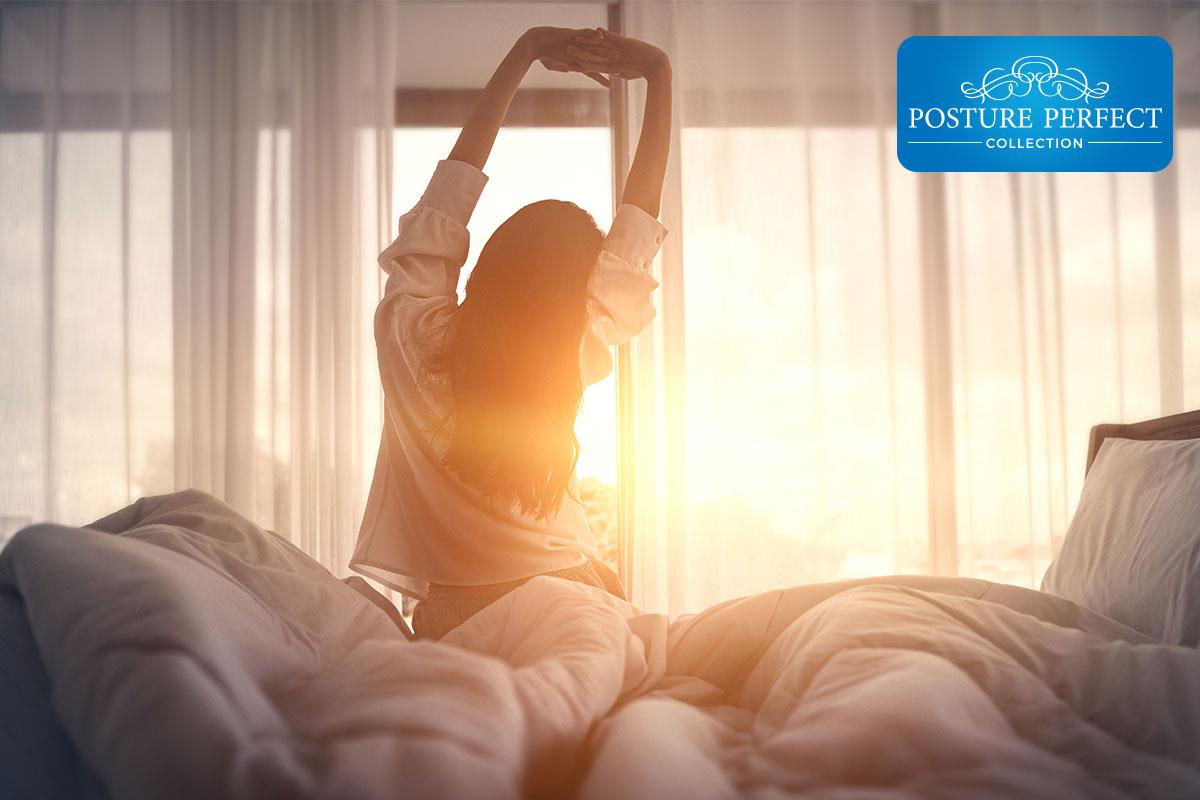 lady waking from a restful sleep on a mattress company mattress