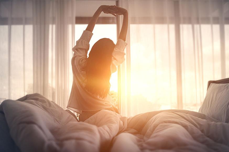 Woman stretching on comfortable mattress